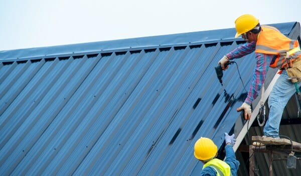 men working on metal roof