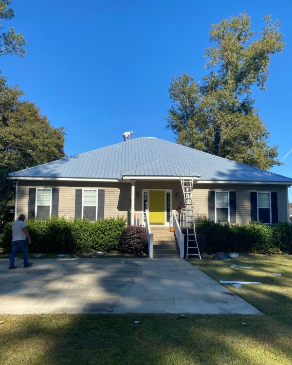employees working on a metal roof repair